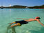 Man floating on his back in the Whitsunday's crystal clear waters.