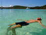 Man floating on his back in the Whitsunday's crystal clear waters.