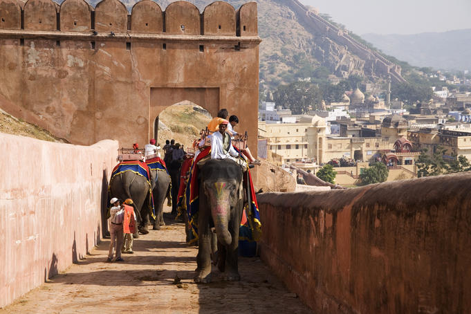 Tourists arrive by elephant at Amber Palace.