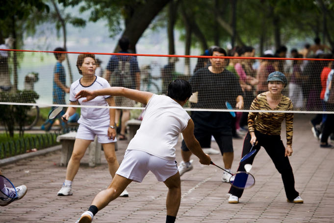 Playing badminton beside Hoan Kiem Lake.