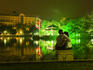 Couple hugging by Hoan Kiem Lake at night, Old Quarter.