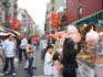 Confectionery stand and bustling Mulberry Street, Little Italy.