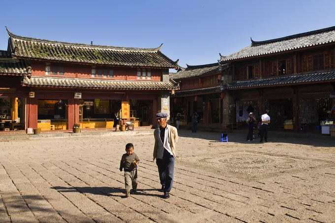Man and child walking through Shuhe (Old town) market place.
