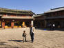 Man and child walking through Shuhe (Old town) market place.