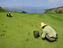 Workers on green at Spring City Golf Course, looking towards Lake Yangzong.