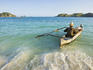 Fisherman paddling his boat out from Kuta Beach.