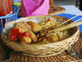 Fried food, noodles and rice served in a basket at Grand Puncak Sari Restaurant.