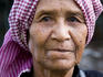 Portrait of flower seller at Psar Nat market wearing a Krama (traditional checkered scarf worn by Khmers).