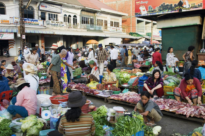 Shoppers and vendors with a variety of meat and produce at Psar Nat market.