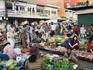 Shoppers and vendors with a variety of meat and produce at Psar Nat market.