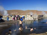 Tourists bathing in the hot water of El Tatio Geysers, Atacama Desert.