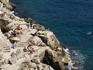Swimmers and sunbathers enjoying the rocks outside the south wall.