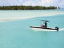 Motorboat cruising through the turquoise waters of Bora Bora Lagoon.