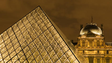 Musee du Louvre pyramid at dusk.