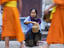 Lady giving rice to monks, Laos
