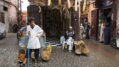 Shopkepper and his son outside their medicine shop selling natural remedies.