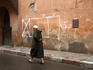 Man hurrying through backstreets of the Marrakesh medina.