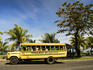 Bus with passengers driving along Beach Road, the main road of Apia.