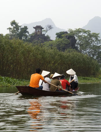 Passenger-laden row boat on the Yen River, en route to Perfume Pagoda (Chua Huong) complex.