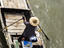 Man rowing his wooden boat.