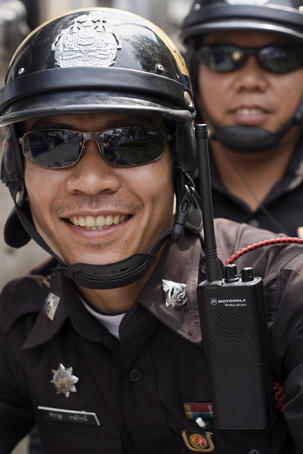 Portrait of policemen getting ready for work at Thanon Sukhumvit.
