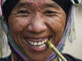 Portrait of woman from Akha tribe smoking a small cigar.