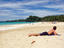 Man sunbathing on beach.