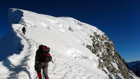 Hiker and his guide ascending to the peak of Nevado Vallunaraju, Cordillera Blanca region.