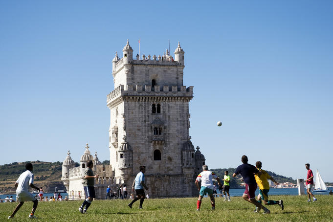 Football game between locals in park next to Torre de Bel