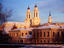 Exteriors of former town hall and twin-towered Jesuit church.