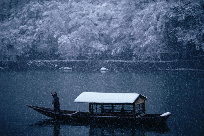 A traditional leisure boat during a snowfall at Arashiyama west of Kyoto.