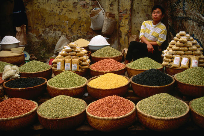A woman selling nuts and beans at the market