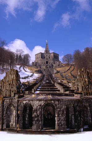 Water cascades lead to the Herkules monument sitting atop a huge stone pyramid on an octagonal amphitheatre on the impressive hillside.