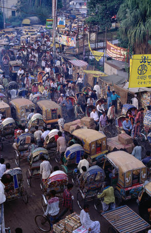 Rickshaws and baby taxis fight for space on the streets of Dhaka, these scooter like vehicles are known as auto-rickshaws in India