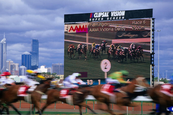 A big screen backdrops the 1999 Victoria Derby at Flemington.