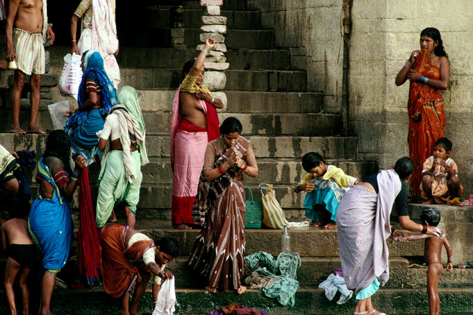 Washing clothes, children and praying on the ghats by the River Ganges - Varanasi, Uttar Pradesh