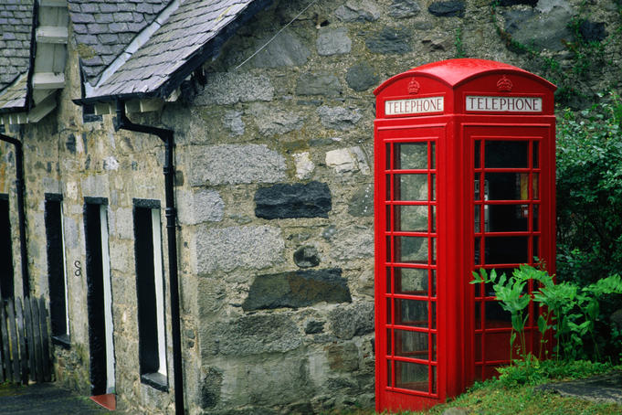 A traditional red telephone box in the Grampian Mountains - Highland, Scotland