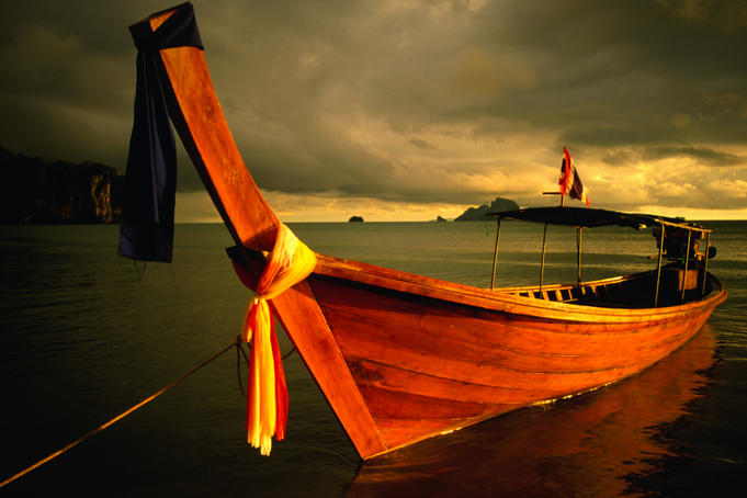 Longtail boat with ribbons.