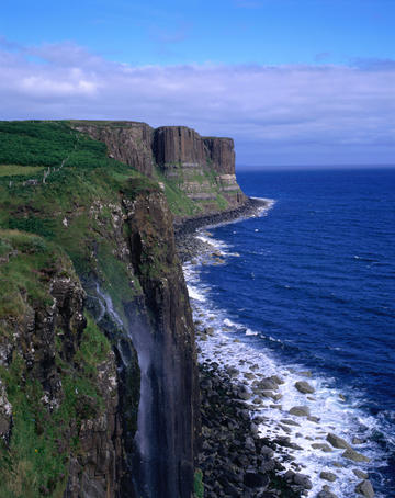 The Kilt Rock Waterfall drops dramatically to the sea down the sheer face of the cliffs on the Trotternish Peninsula, Isle of Skye - Scotland