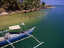 Swimming at mouth of Agno River in front of bangka (boat).