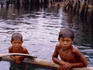 Boys on a small outrigger bangka (boat) in Basilan harbour- Basilan island, the Philippines