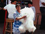 A woman carrying a stuffed animal near Mercado Central