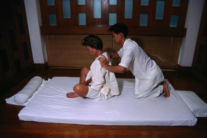 Tourist receiving a Traditional Thai or ancient massage, at the Oriental Hotel.