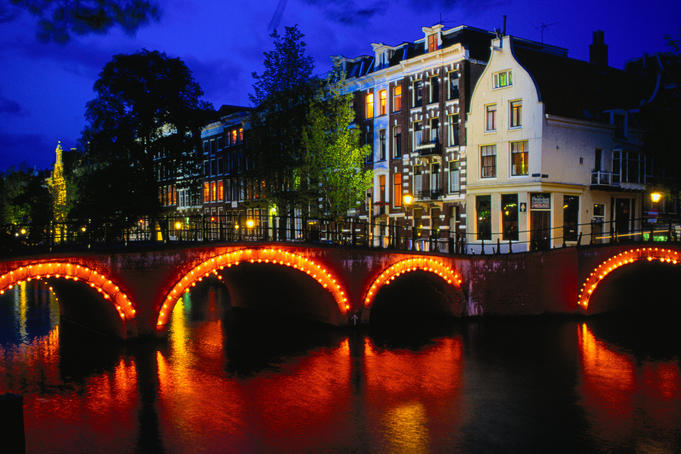 Illuminated canal and houses.