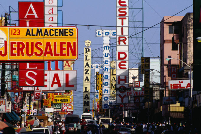Signs, shops, traffic and people, all on Duarte Avenue, Santo Domingo