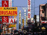 Signs, shops, traffic and people, all on Duarte Avenue, Santo Domingo