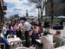 Waiters taking orders at a crowded outdoor cafe on Place Cartier