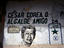 A political mural with bullet holes