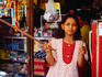 Girl working at shop at Ampenan market.