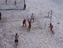 People playing beach volleyball on Prado Beach.